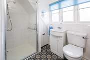 The bathroom has a large shower cubicle.