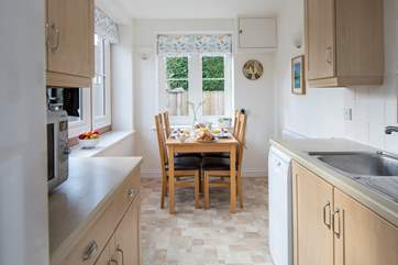 The kitchen and dining-area are flooded with light.