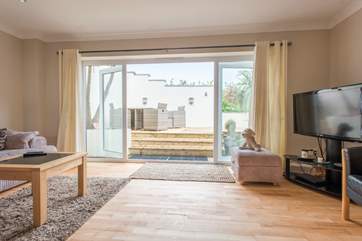 Doors open onto the decked terrace.
