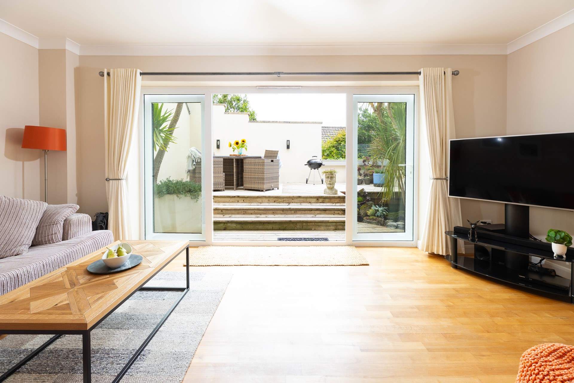 Doors open onto the decked terrace.