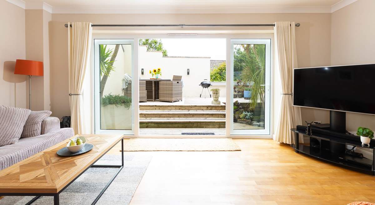 Doors open onto the decked terrace.