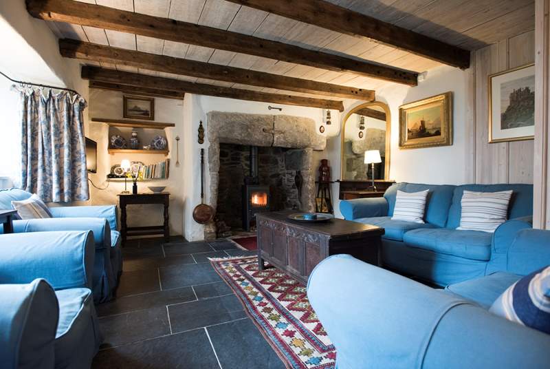 The sitting-room with gorgeous slate floor and traditional oak beams.