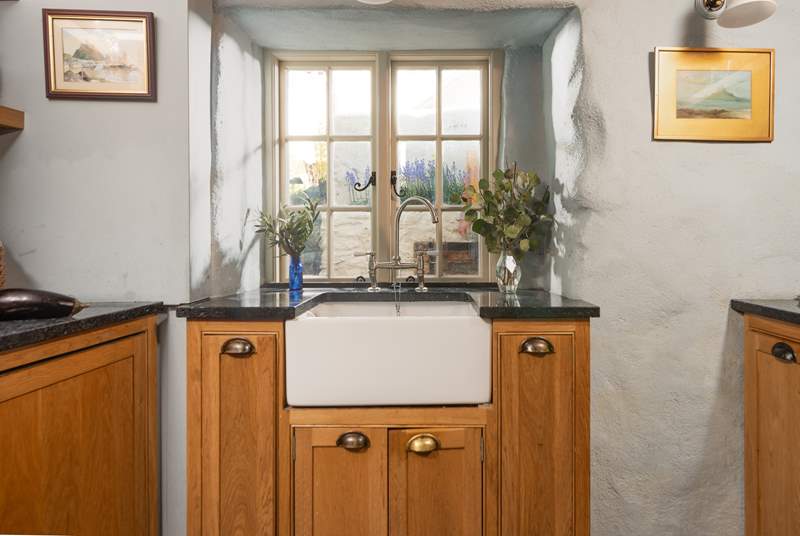 The cottage style kitchen has a Belfast sink.