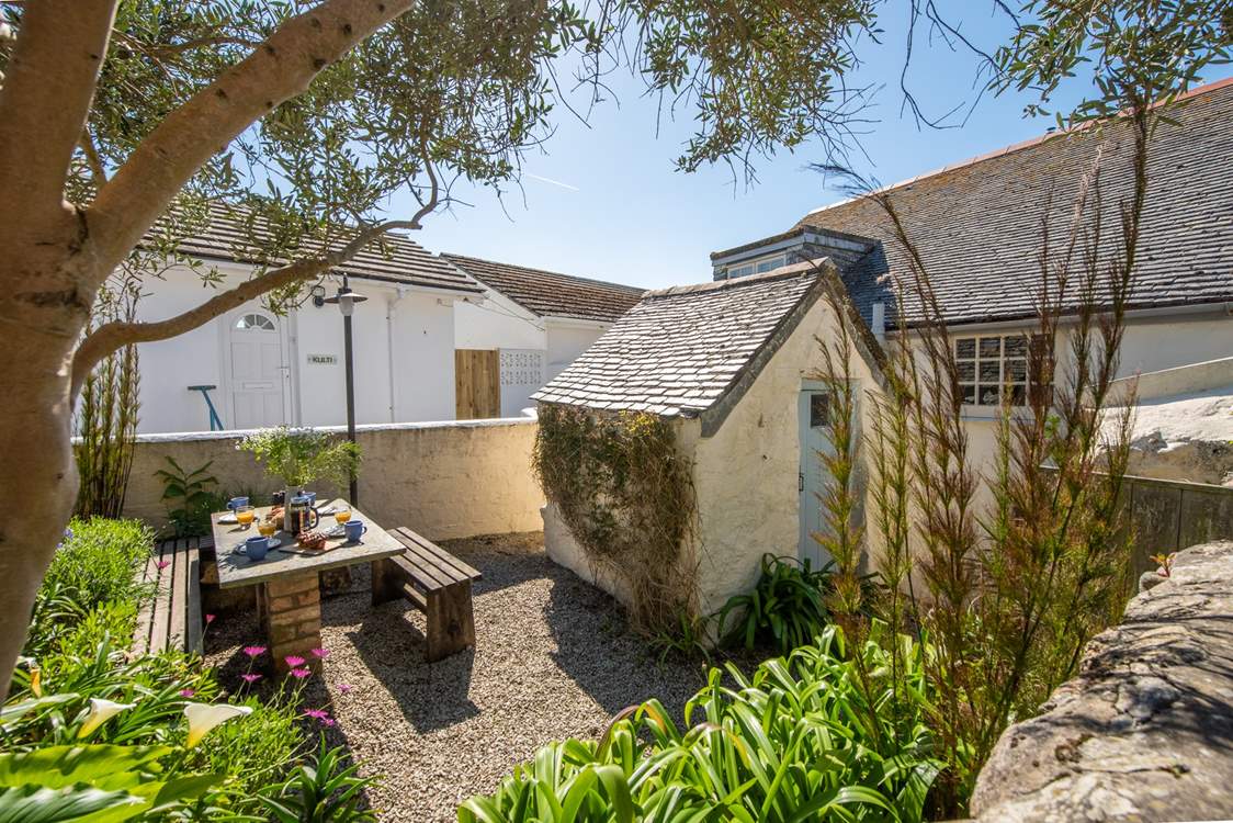 The secluded rear patio garden is perfect for al fresco dining.