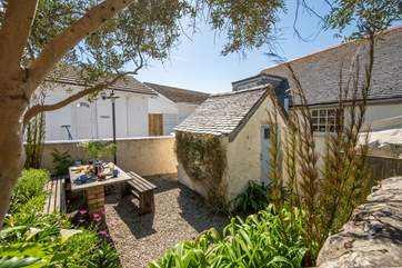 The secluded rear patio garden is perfect for al fresco dining.