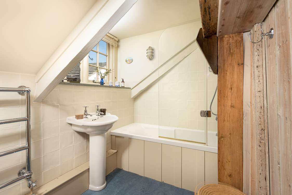 The family bathroom has a bath with fitted shower.