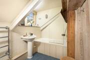 The family bathroom has a bath with fitted shower.