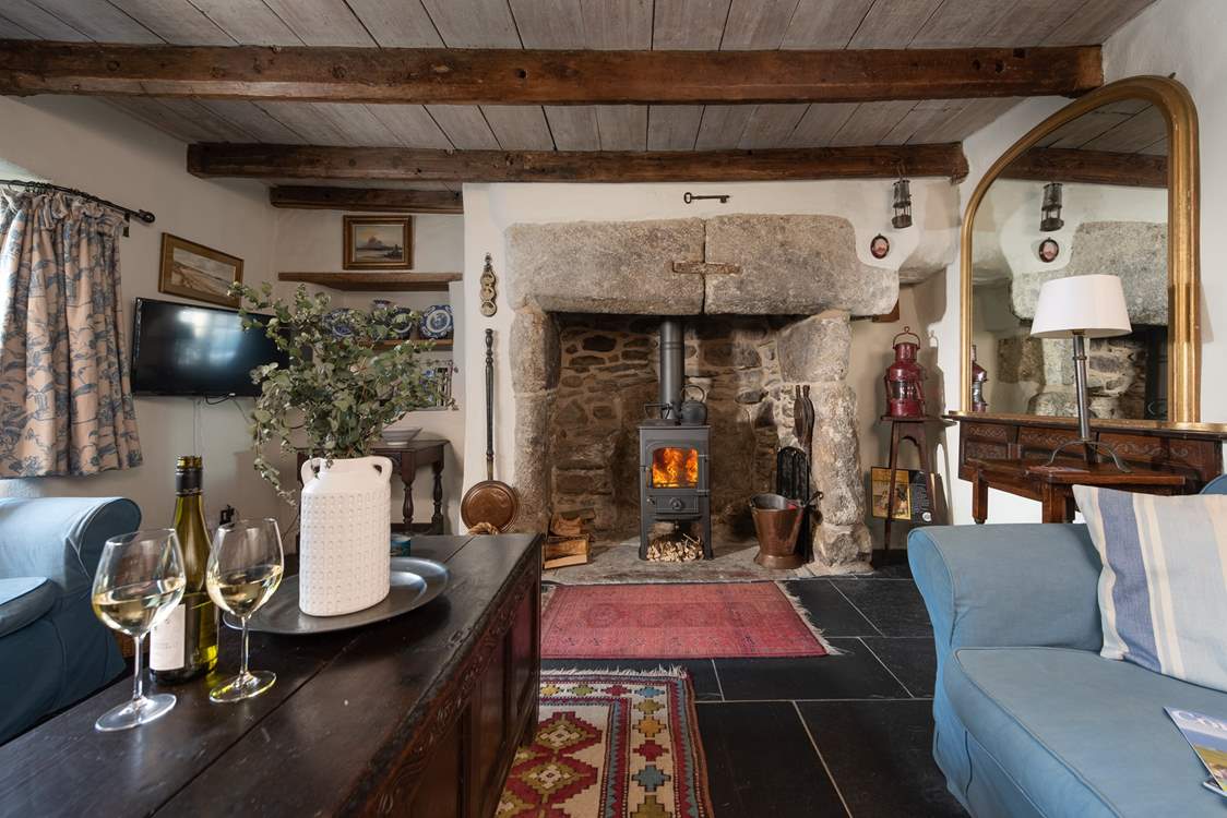 The gorgeous inglenook feature fireplace is the centre piece in the sitting-room.