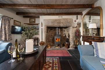 The gorgeous inglenook feature fireplace is the centre piece in the sitting-room.