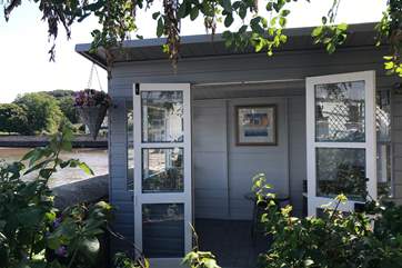 The beautiful waterfront summer-house with views of the estuary is across the lane from the cottage. What a fabulous place to sit and watch the world go by.....