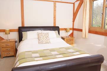 This bedroom has dual-aspect windows, overlooking the woods that run along the bridlepath behind the lodge and the field to the front.
