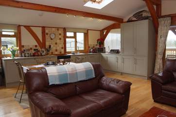 There is plenty of space for the dining-table and the well-equipped kitchen.