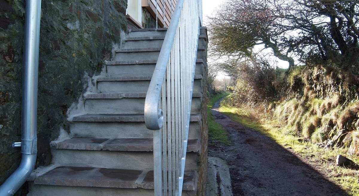 Steps access the cottage and the adjoining footpath leads up to the top of the Beacon.