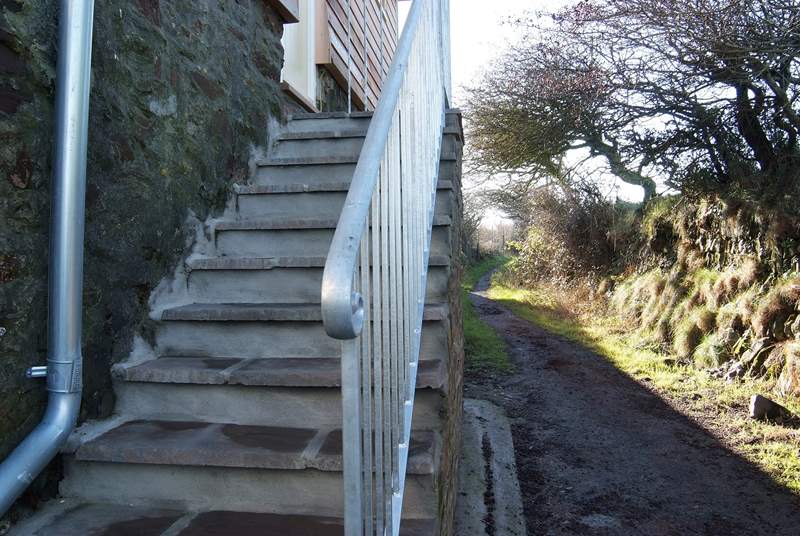 Steps access the cottage and the adjoining footpath leads up to the top of the Beacon.