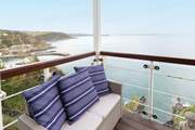 The covered balcony provides a grandstand view of Mevagissey harbour and bay.