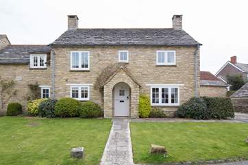 An open garden at the front and enclosed garden at the rear of this pretty cottage.