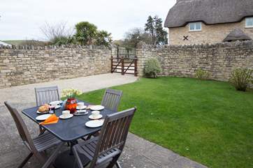 To the rear of the cottage, the enclosed garden and private parking; it is easier to reverse through the gates, as the turning circle is quite tight.