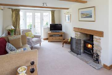 The sitting-room has a wood-burner and French doors to the enclosed rear garden.