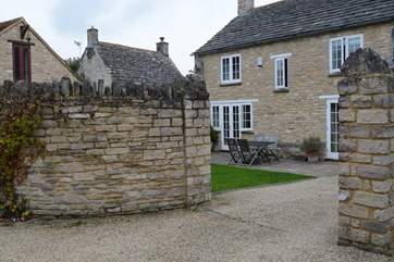 Two sets of French doors lead out onto the patio and enclosed garden. This is the entrance to the garden, it is easier to reverse in through the gates as it is a little tight.