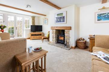 The sitting-room has a wood-burner and French doors to the enclosed rear garden.