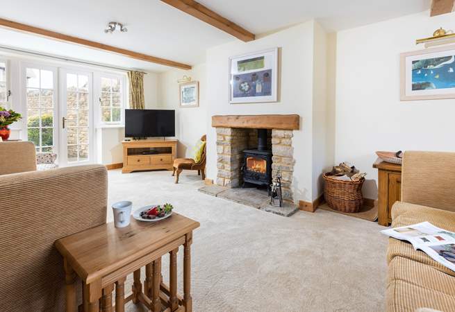 The sitting-room has a wood-burner and French doors to the enclosed rear garden.