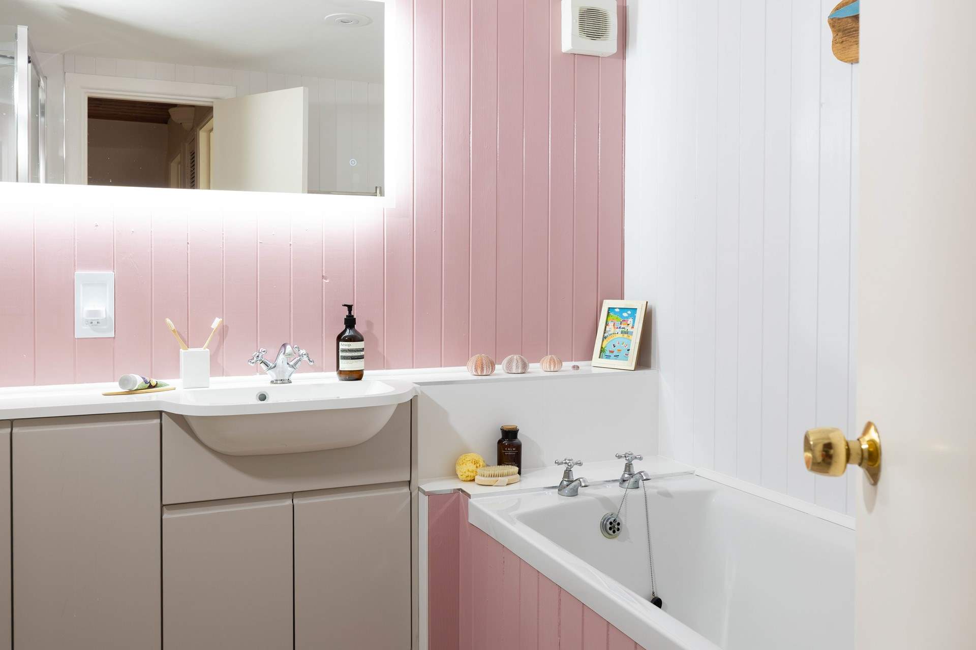 Enjoy a soak in this pink bathroom. 