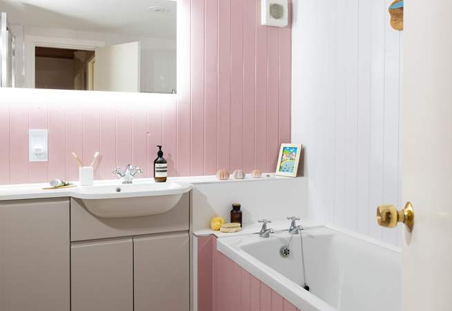 Enjoy a soak in this pink bathroom. 