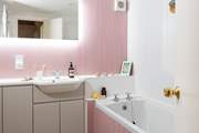 Enjoy a soak in this pink bathroom.
