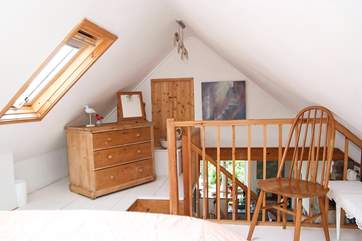 The bedroom is furnished with antique pine.