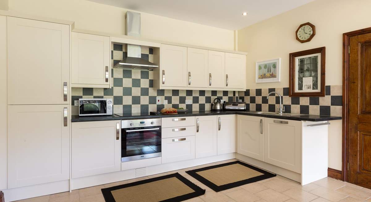 The extremely well-equipped kitchen is set at the far end of the dining-room. The utility-room is through the door to the right of the picture.