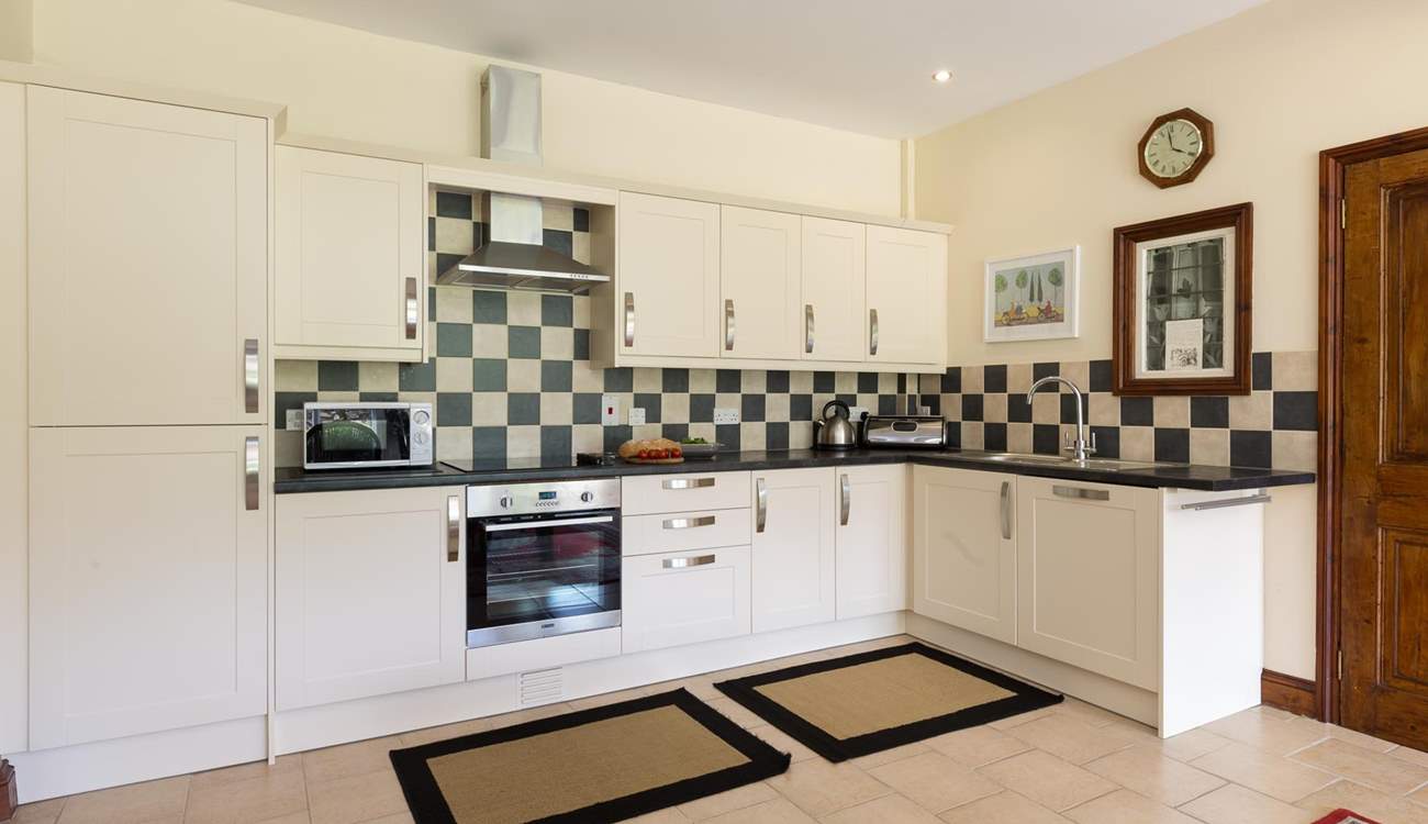 The extremely well-equipped kitchen is set at the far end of the dining-room. The utility-room is through the door to the right of the picture.