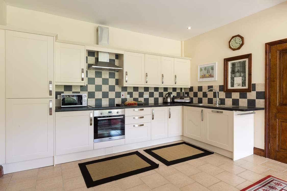 The extremely well-equipped kitchen is set at the far end of the dining-room. The utility-room is through the door to the right of the picture.