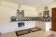 The extremely well-equipped kitchen is set at the far end of the dining-room. The utility-room is through the door to the right of the picture.