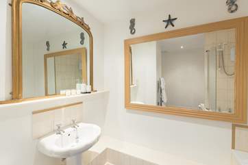 Across the corridor from the second bedroom is a huge bathroom, with bath and fitted shower.