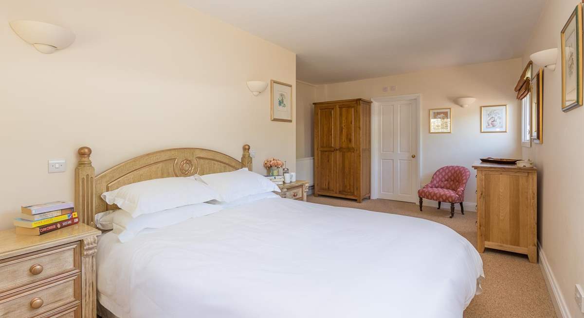 The main bedroom has plenty of space and a luxurious king-size bed.