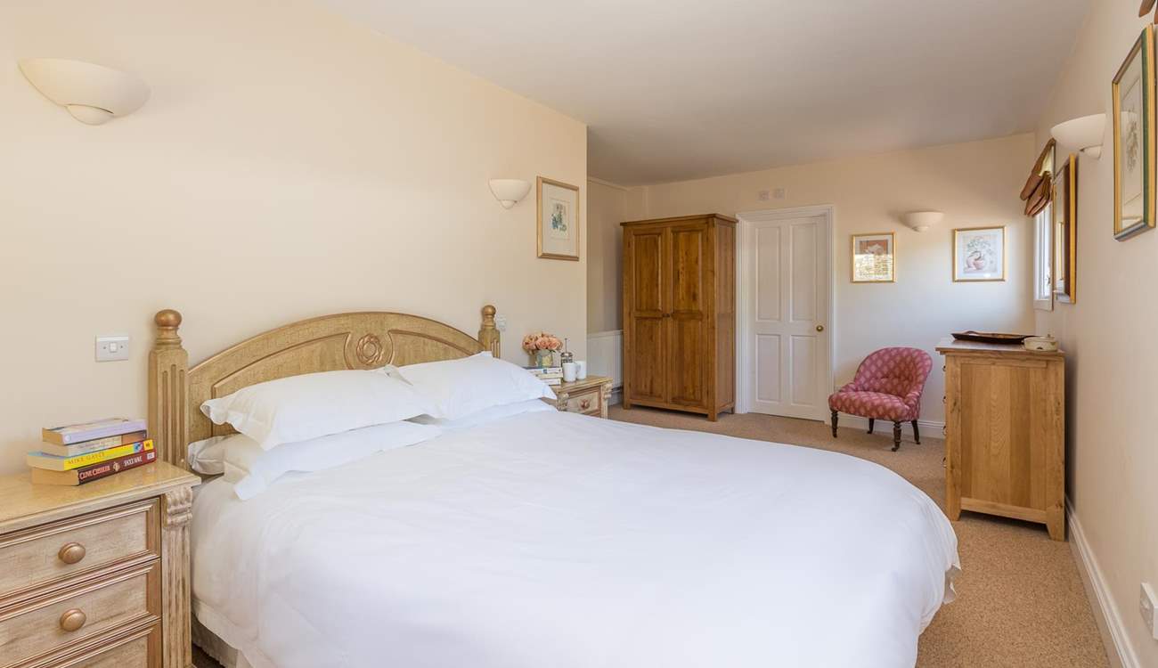 The main bedroom has plenty of space and a luxurious king-size bed.