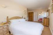 The main bedroom has plenty of space and a luxurious king-size bed.