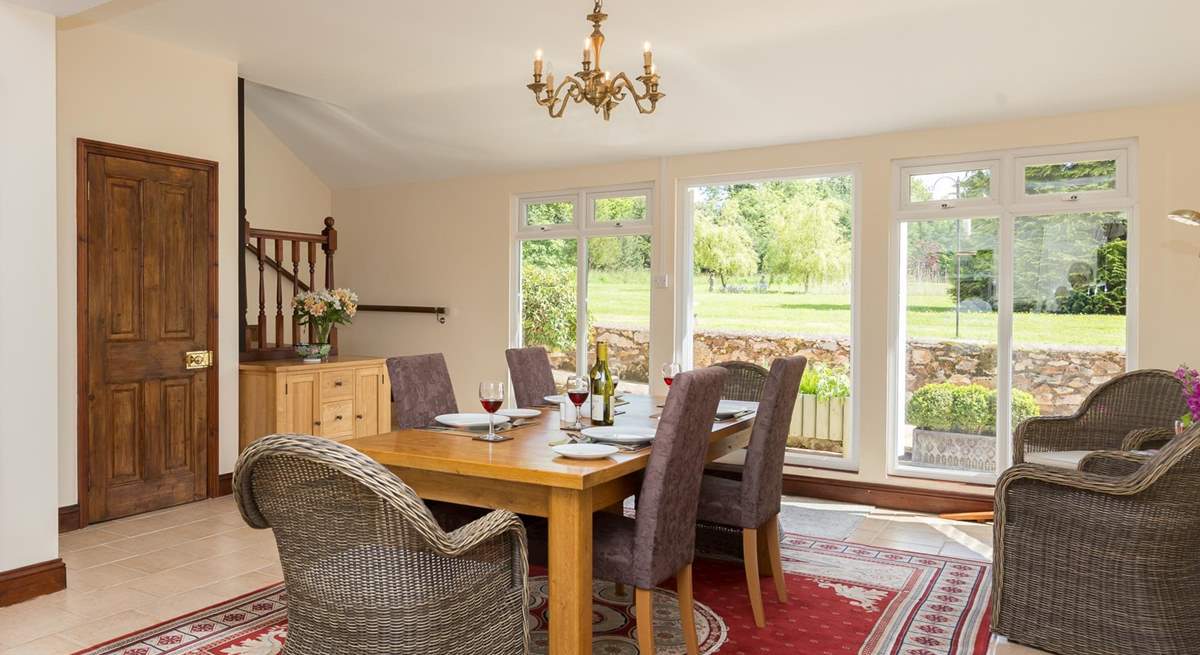 The spacious kitchen/dining-room looks out over the gardens. The stairs in the corner lead to the living-room.