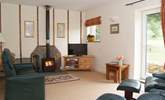 The living-room has a choice of wonderfully comfortable reclining chairs, with a wood-burning stove for out-of-season evenings. - Thumbnail Image