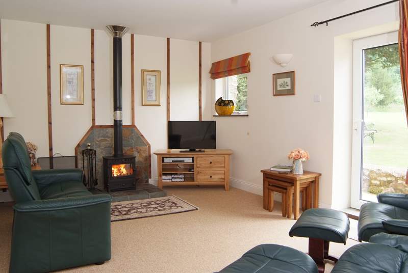 The living-room has a choice of wonderfully comfortable reclining chairs, with a wood-burning stove for out-of-season evenings.