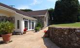 This is the pathway to the entrance for Mount Pleasant Lodge. Beautiful plants in pots, a little herb garden and the secluded patio around the far corner. - Thumbnail Image