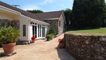 This is the pathway to the entrance for Mount Pleasant Lodge. Beautiful plants in pots, a little herb garden and the secluded patio around the far corner.
