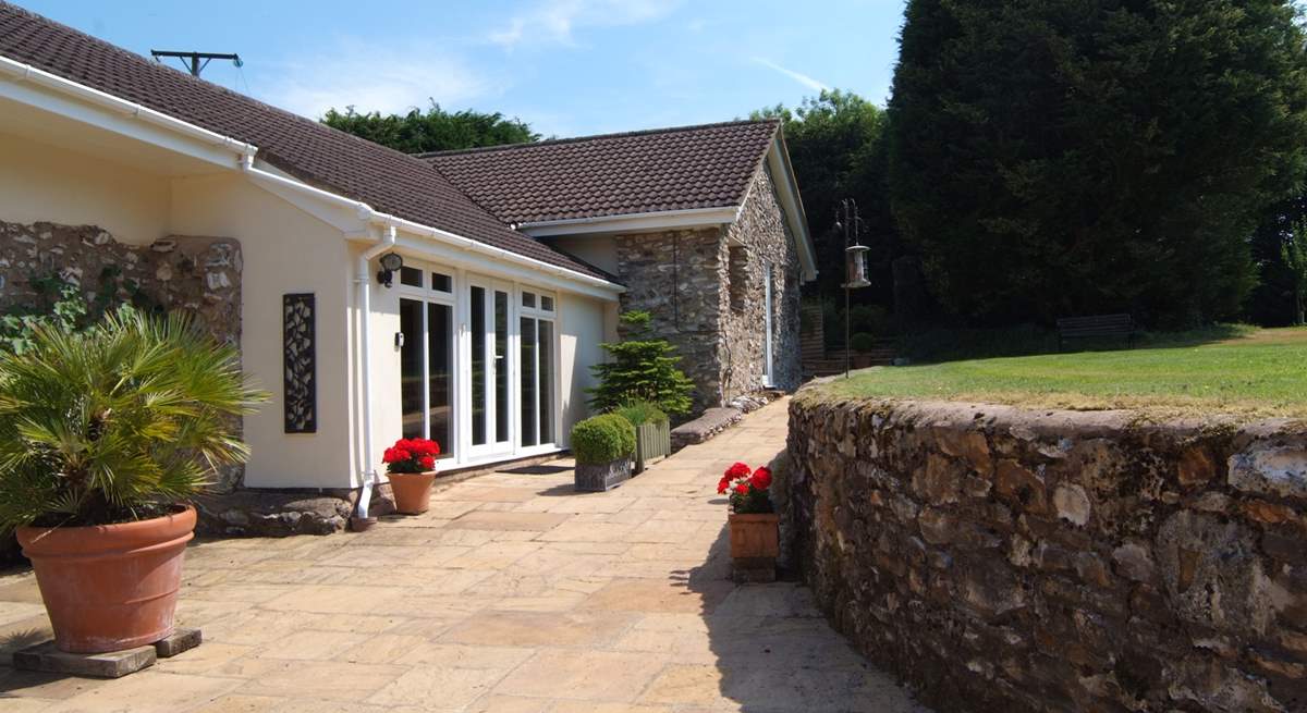 This is the pathway to the entrance for Mount Pleasant Lodge. Beautiful plants in pots, a little herb garden and the secluded patio around the far corner.