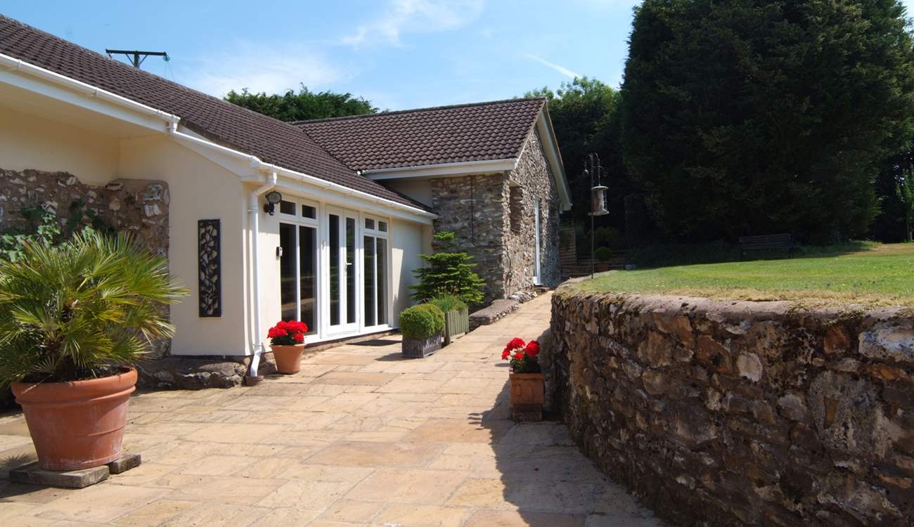 This is the pathway to the entrance for Mount Pleasant Lodge. Beautiful plants in pots, a little herb garden and the secluded patio around the far corner.