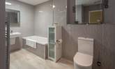 A super spacious and modern bathroom awaits. Perfect for unwinding in after a full day of adventure. - Thumbnail Image