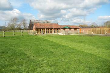The Old Barn in its open setting. The barn behind the cottage provides covered parking for guests and secure storage for bicycles etc.