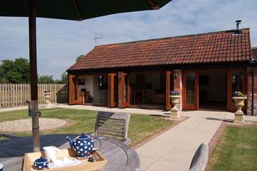 Looking towards the barn with its Bi-fold doors opened up all along the front.