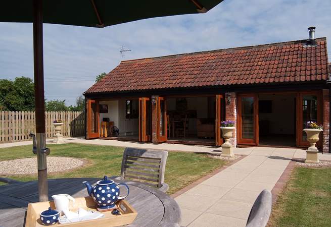 Looking towards the barn with its Bi-fold doors opened up all along the front.