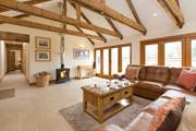 There is a high-ceiling open plan living space, with wonderful Bi-fold doors that open up the side of the barn to the garden.