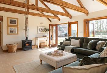 There is a high-ceiling open plan living space, with wonderful bi-fold doors that open up the side of the barn to the garden.